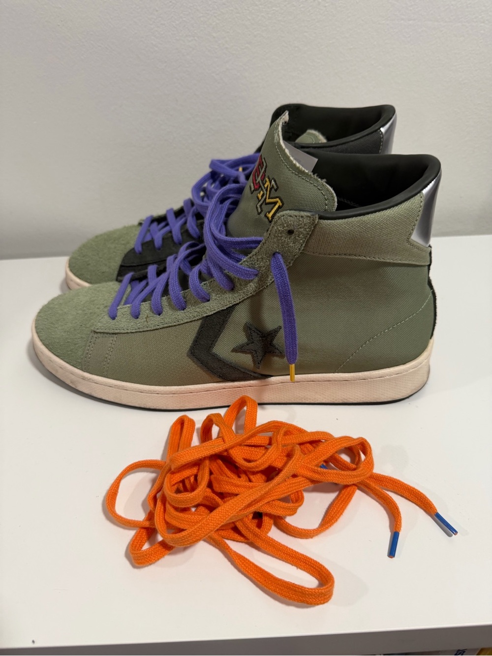 Converse High-Top Sneakers in Olive Green with Purple Laces